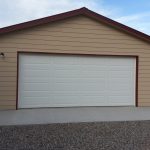 Photo of a brown garage with a white double garage door
